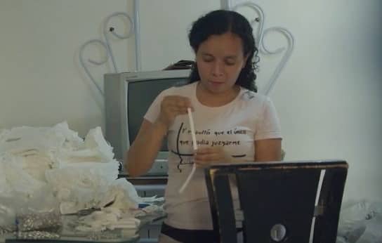 woman preparing footbags behind computer